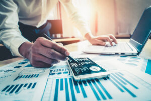 Businessman accountant or financial expert analyze business report graph and finance chart at corporate office. 